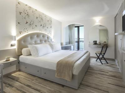 Elegant room with double bed and balcony.