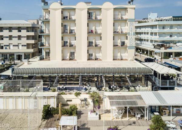 Hotel fronte mare con terrazza e spiaggia.